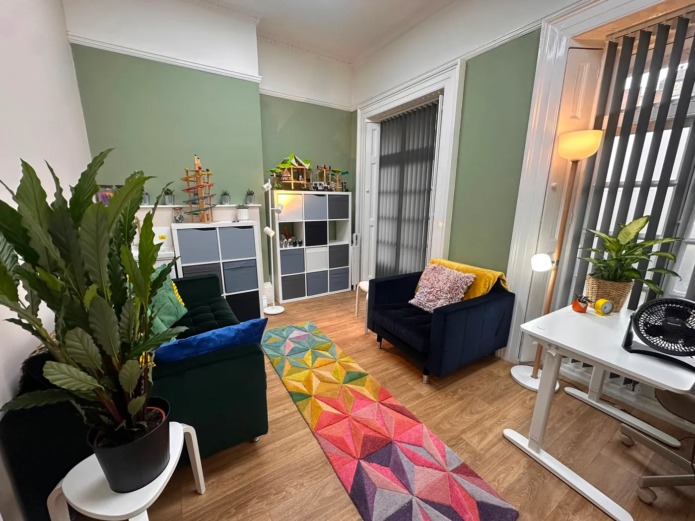 The consulting room at the NeuroFX Bedford clinic, with soft seating, sensory toys, plants and a colourful rug