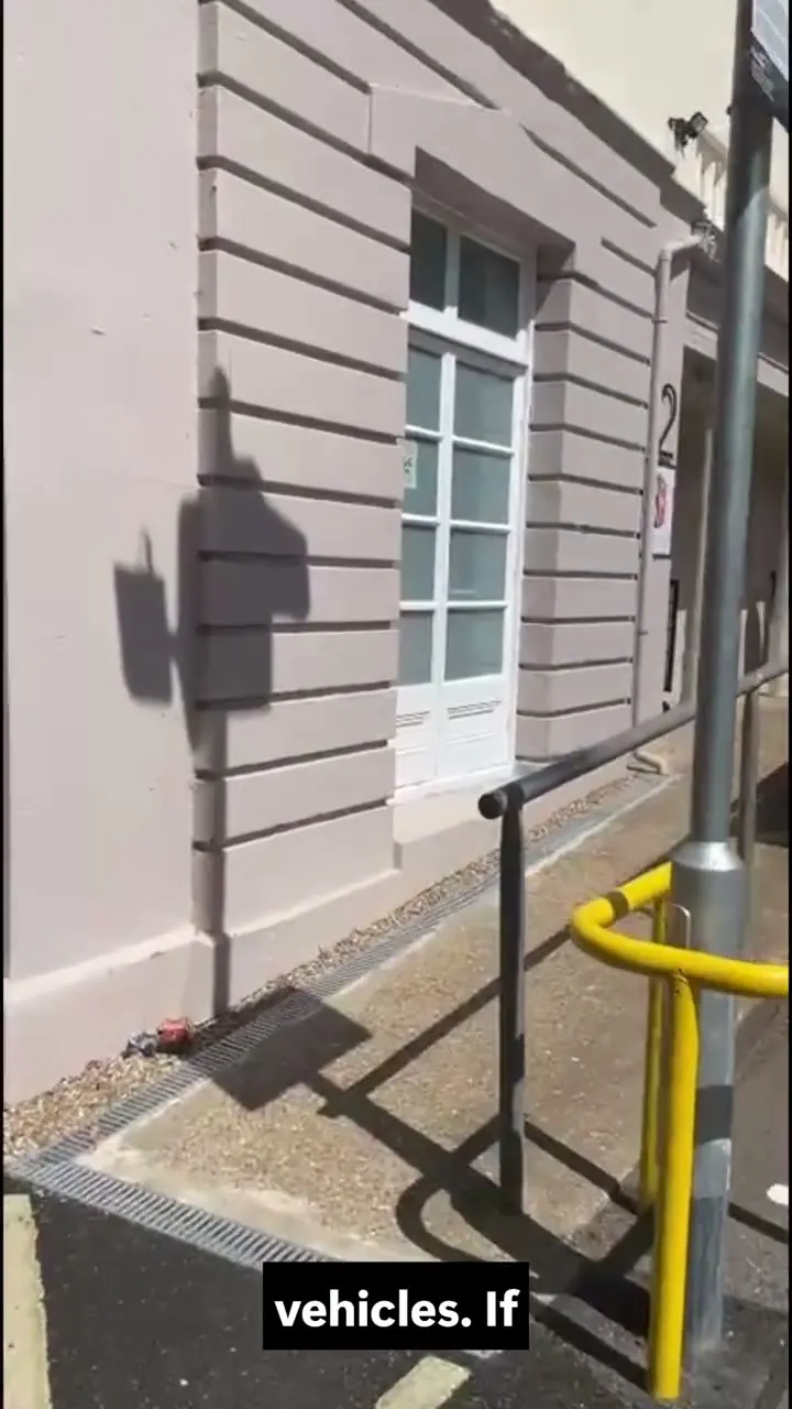 The front of 2 Goldington Road, showing the sloped approach and handrail to the front door