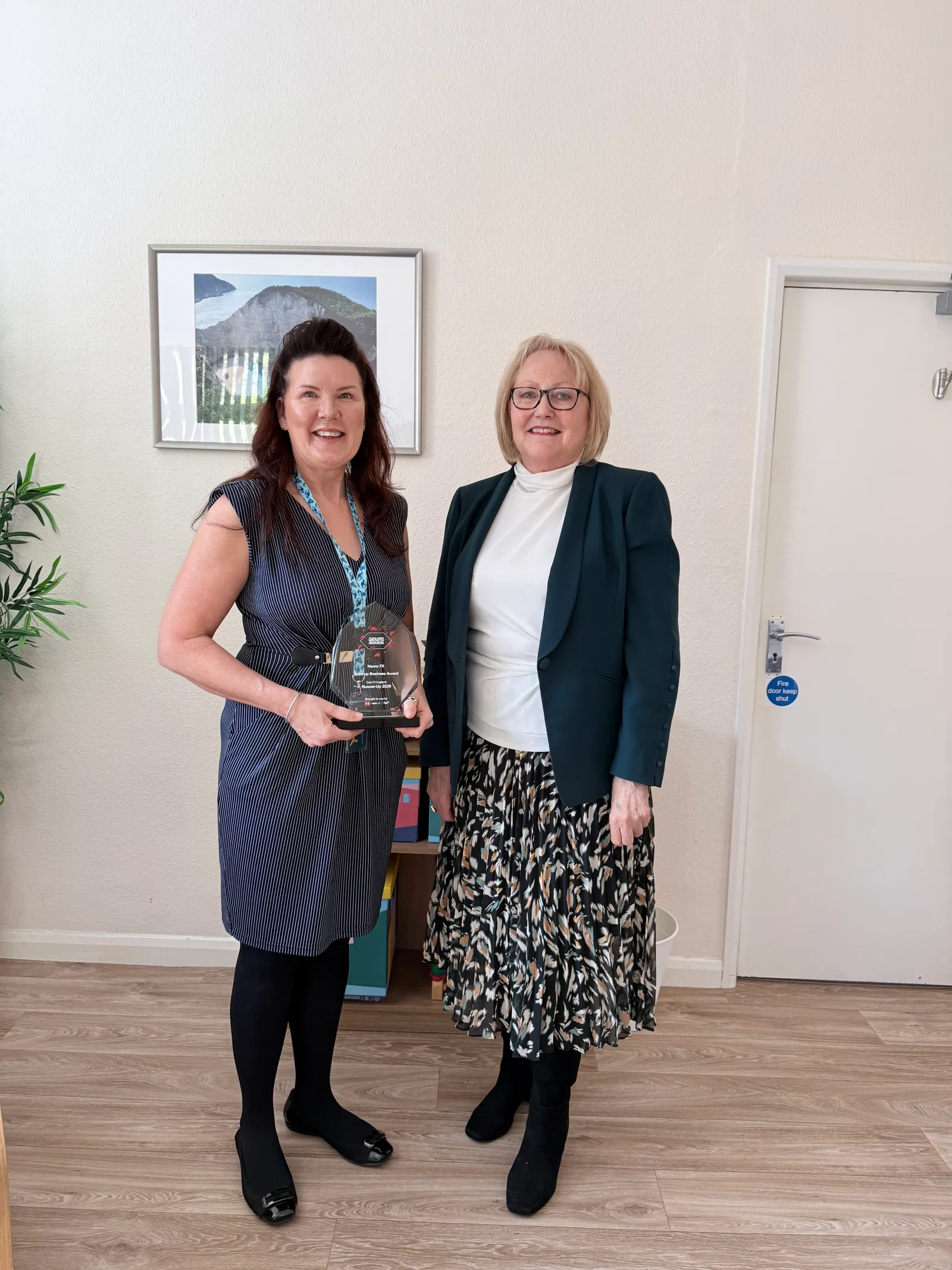 Tina Fox holding the NeuroFX Small Business Growth Awards regional runner-up trophy at the Bedford clinic