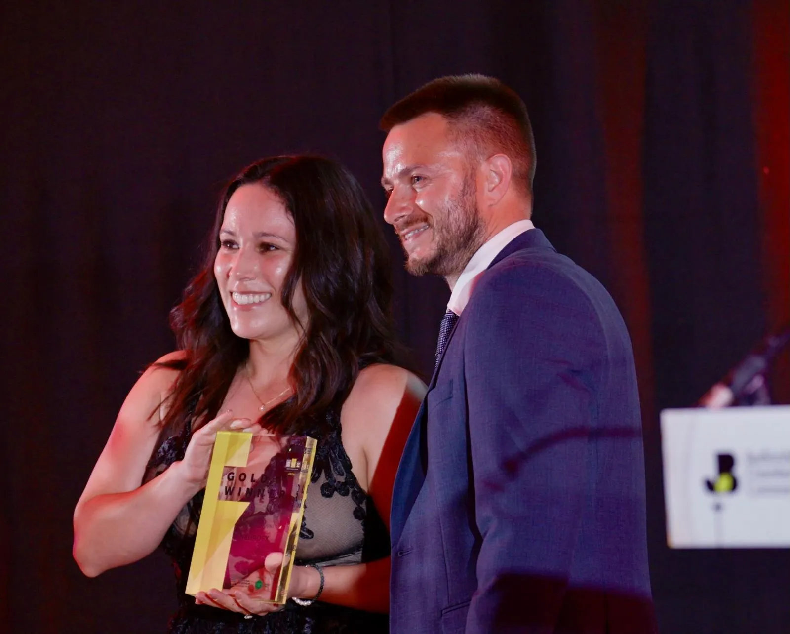 Cheyenne collecting the NeuroFX Best New Business Gold Winner trophy on stage at the SME Bedfordshire Business Awards 2026