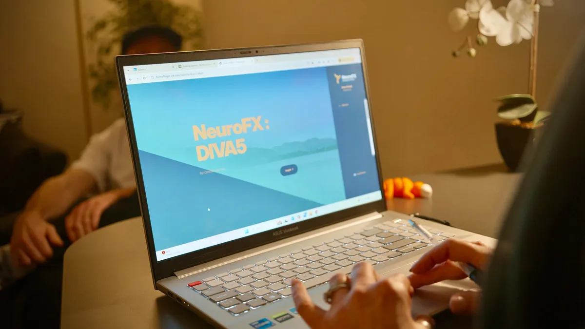 A laptop showing the NeuroFX DIVA-5 assessment interface during a clinical session
